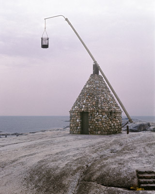 Ancient lighthouse built of rocks along Oslo Fjord in Norway.  The basket was filled with coal and lit for light.