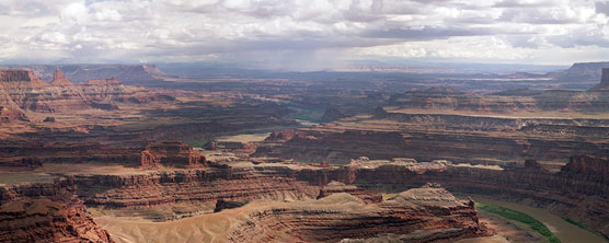 View of a distant rain storm from the Rim Walk,  which towers 2000 feet directly above the Colorado River. The mesa that is Dead Horse Point provides breathtaking views of the canyon country and storms of southeastern Utah and the pinnacles and buttes of Canyonlands National Park. This is also the site of an iconic scene from the movie "Thelma and Louise".