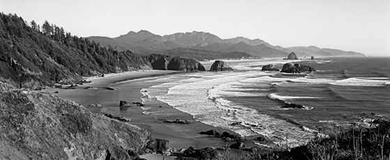 Classic view of the afternoon surf from Ecola State Park near Cannon Beach.  The beach in the foreground is called Crescent Beach and in the distance you can see the town of Cannon Beach and Haystack Rock. 