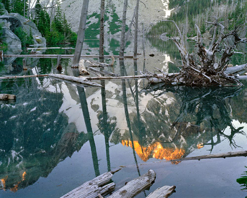 Sunrise on Dragontail Peak reflected in Colchuck Lake on the Enchantment Lakes Loop Trail. The notch between the mountains is known a Aasgard Pass.