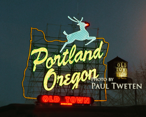 The iconic "Portland,  Oregon" sign from the Burnside Bridge at Christmas. The sign has gone through several evolutions,  but has always had the map of Oregon. The "White Stag" clothing company added the deer and the city of Portland added the current text. Every Christmas,  a red light is added to the deer's nose to liven the season.
