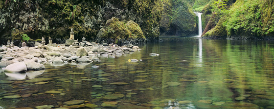 Rock cairns adorn the banks of Eagle Creek in the Columbia River Gorge at Punchbowl Falls.